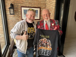 Sun photographer Jack (Boston Bruin) Boland got a little surprise from former Bruin’s Coach Don Cherry — a special legends T-shirt, which everybody knows Jack will wear since he’s always in Boston colours.