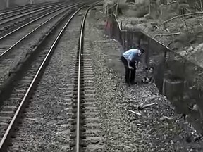 Assistant Conductor Marcus Higgins rescues a child near train tracks in New York.