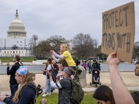 People attend a rally as part of a Transgender Day of Visibility, Friday, March 31, 2023, by the Capitol in Washington.