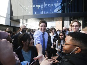 Prime Minister Justin Trudeau greets students outside the University of Manitoba Faculty of Engineering in Winnipeg on Wednesday, April 12, 2023. Trudeau spent the day in the city promoting his government's new budget.