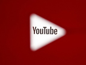 A 3D-printed YouTube icon is seen in front of a displayed YouTube logo in this illustration taken October 25, 2017.