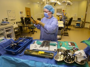 A scrub nurse prepares surgical instruments in an operating room at Belleville General Hospital in Belleville, Ont., April 28, 2014.
