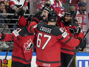 Canada's Tyler Myers celebrates scoring their second goal with teammates.