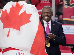 Hugh Fraser, Hockey Canada board chair, prepares the gold medals at the IIHF world junior hockey championship in 2023.