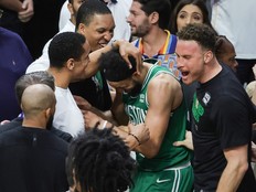 Derrick White celebrates with teammates.
