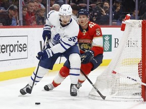 Gustav Forsling of the Florida Panthers trails Michael Bunting of the Toronto Maple Leafs as he circles the net with the puck during second period action at the FLA Live Arena on April 10, 2023 in Sunrise, Florida.