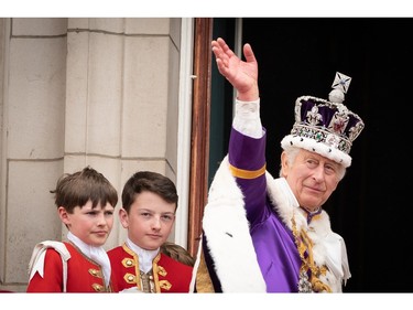 King Charles III waves as he leaves the balcony of Buckingham Palace following the coronation on May 6, 2023 in London.