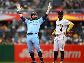 Blue Jays' Brandon Belt reacts after hitting a double in front of Rodolfo Castro of the Pirates during the fifth inning at PNC Park on May 7, 2023 in Pittsburgh.