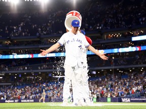 Chris Bassitt, of the Toronto Blue Jays, is doused with water by Vladimir Guerrero Jr. after throwing a complete game against the Atlanta Braves at Rogers Centre in Toronto on May 12, 2023.