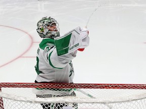 Jake Oettinger of the Dallas Stars sprays water in the air during the second period against the Seattle Kraken.