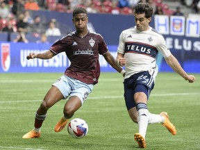 Vancouver Whitecaps FC forward Brian White (24) challenges Colorado Rapids defender Max Alves.