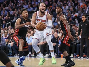 New York Knicks guard Jalen Brunson drives past Miami Heat guard Kyle Lowry (7) and forward Jimmy Butler (22) during Game 5.