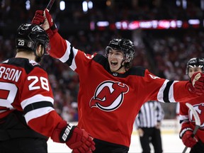 Damon Severson #28 of the New Jersey Devils celebrates his goal with teammates Luke Hughes #43 and Jack Hughes #86 during the second period in Game Three of the Second Round of the 2023 Stanley Cup Playoffs against the Carolina Hurricanes at Prudential Center on May 07, 2023 in Newark, New Jersey.
