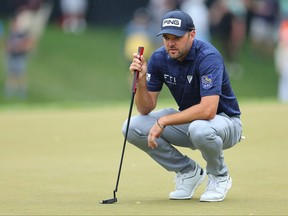 Corey Conners of Canada lines up a putt on the 18th green during the second round of the 2023 PGA Championship at Oak Hill Country Club on May 19, 2023 in Rochester, N.Y.