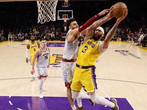 Anthony Davis #3 of the Los Angeles Lakers is guarded by Jamal Murray #27 of the Denver Nuggets.