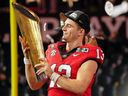 Georgia Bulldogs quarterback Stetson Bennett holds the trophy after winning the CFP national championship game.