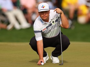 Sungjae Im of Korea places his ball on the 18th green during the final round of the Wells Fargo Championship.