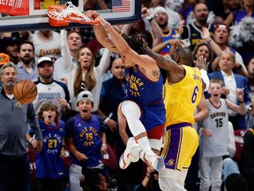 Denver Nuggets forward Aaron Gordon dunks the ball against Los Angeles Lakers forward LeBron James.