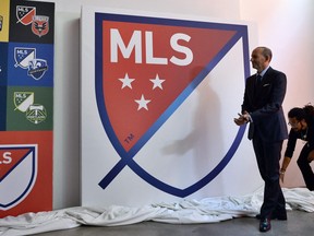 Major League Soccer commissioner Don Garber unveils the MLS logo.