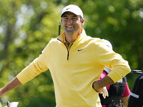 Scottie Scheffler smiles as he waits to tee off on the 15th hole during the first round of the PGA Championship.