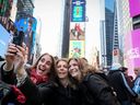 Fans take a photo during the New York/New Jersey’s FIFA World Cup 2026 Kickoff event in Times Square.