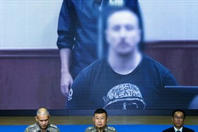 Matthew Dupre's image appears on a screen in Bangkok, Thailand
