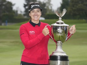 Hannah Green poses for photos with the winner's trophy after winning in a playoff in the LPGA LA Championship golf tournament at Wilshire Country Club, Sunday, April 30, 2023, in Los Angeles.
