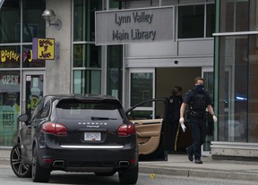 Members of the RCMP seen outside Lynn Valley Library in North Vancouver