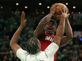 Jimmy Butler of the Miami Heat is defended by Marcus Smart of the Boston Celtics.