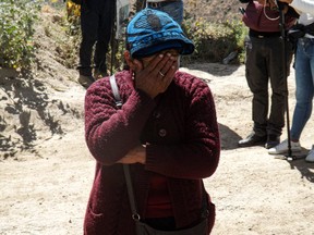 A relative of a worker cries as she waits at the entrance of the La Esperanza mine, where at least 27 people died in the Yanaquihua district of Arequipa, southern Peru, on May 7, 2023.