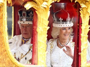 King Charles and Queen Camilla travel from Westminster Abbey in the Gold State Coach, following their coronation ceremony in London, May 6, 2023.