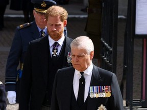 Prince Andrew and Prince Harry, Duke of Sussex, walk after a service at Westminster Abbey on the day of the state funeral and burial of Queen Elizabeth, in London, Sept. 19, 2022.