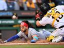 Bo Bichette of the Toronto Blue Jays scores in front of Austin Hedges of the Pittsburgh Pirates.