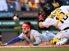 Bo Bichette of the Toronto Blue Jays scores in front of Austin Hedges  of the Pittsburgh Pirates during the first inning of the game at PNC Park on Friday night.