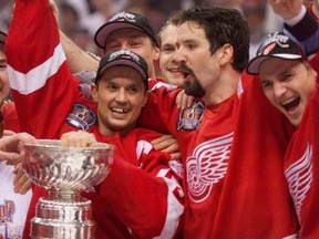 Brendan Shanahan, centre, flanked by fellow Hockey Hall of Famers Steve Yzerman, left, and Sergei Fedorov, right, celebrate their second straight Stanley Cup title together in 1998 after the Detroit Red Wings beat the Washington Capitals. Today’s edition of the Maple Leafs could use some of their team president’s moxie and post-season goal-scoring ability.