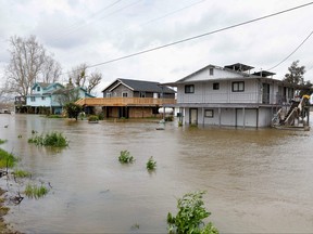 Houses sit partly underwater after the flooding of the San Joaquin River in Manteca, Calif.
