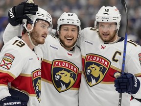 Florida Panthers' Brandon Montour (centre) celebrates his goal with teammates Matthew Tkachuk (left) and Aleksander Barkov during the third period of Game 1 of their second-round series against the Maple Leafs.