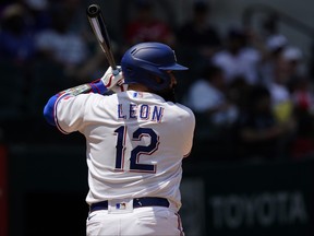 Texas Rangers' Sandy Leon stands at bat during a baseball game against the Arizona Diamondbacks in Arlington, Texas, Wednesday, May 3, 2023. Veteran big league catcher Sandy León changed his uniform to No. 12 this season with the Texas Rangers to remind himself of the worst day of his life.