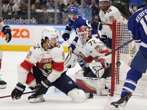 Maple Leafs' Alexander Kerfoot tries to get his stick on the puck as Florida Panthers goaltender Sergei Bobrovsky and Panthers defenceman Brandon Montour look on during the second period in Game 2 of their second-round NHL playoff series in Toronto on Thursday May 4, 2023.