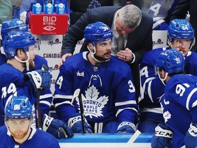 Maple Leafs head coach Sheldon Keefe speaks to Auston Matthews on the bench during a playoff game against the Florida Panthers in Toronto, on Friday, May 12, 2023.
