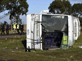 Investigators work at the scene of a bus crash near in Melbourne, Wednesday, May 17, 2023. Seven children remain hospitalized with serious injuries after a truck struck a school bus Tuesday carrying as many as 45 students on the outskirts of Melbourne in southeastern Australia.