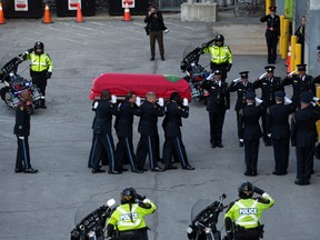 The casket of Ontario Provincial Police Sgt. Eric Mueller is carried into the Canadian Tire Centre during a funeral service in Ottawa, on Thursday, May 18, 2023.