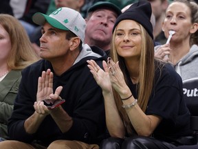 Maria Menounos sits courtside with her husband, Keven Undergaro, during the second half of an NBA basketball game between the Boston Celtics and the Washington Wizards, Sunday, Nov. 27, 2022, in Boston.
