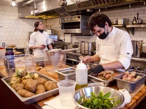 Chef Will Aghajanian prepares dishes in the kitchen at Horses restaurant with wife Elizabeth Johnson in December 2021.