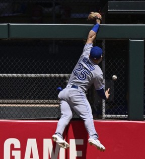 Blue Jays outfielder Daulton Varsho can't hold on to a ball hit by Twins batter Matt Wallner that resulted in a solo home run during the fifth inning at Target Field in Minneapolis, Saturday, May 27, 2023.