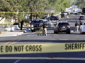 Investigators work along a residential street following a deadly shooting Monday, May 15, 2023, in Farmington, N.M.