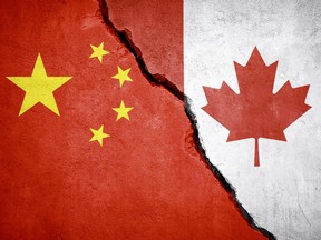 China and Canada conflict. Country flags on broken wall. Illustration. (Istock/Getty Images)