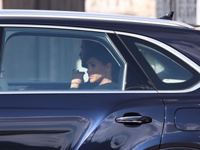Prince Harry, Duke of Sussex and Meghan, Duchess of Sussex depart in a car following the farewell procession for Queen Elizabeth II on September 14, 2022 in London, England. (Photo by Richard Heathcote/Getty Images)