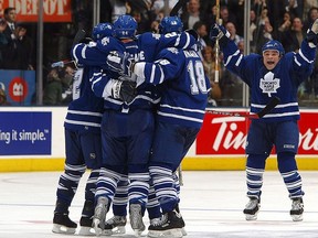 Tie Domi of the Toronto Maple Leafs joins his teammates in celebration of Bryan McCabe's goal against the Ottawa Senators during Game 7 of the Eastern Conference quarter-finals on April 20, 2004 at Air Canada Centre in Toronto, Ontario.