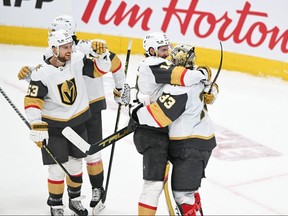 Vegas Golden Knights defenseman Nicolas Hague and goaltender Adin Hill  celebrate defeating the Edmonton Oilers during the third period in game six of the second round of the 2023 Stanley Cup Playoffs at Rogers Place.